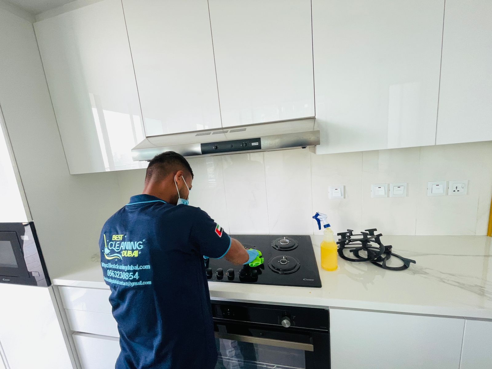 Cleaner mopping a sparkling clean modern kitchen